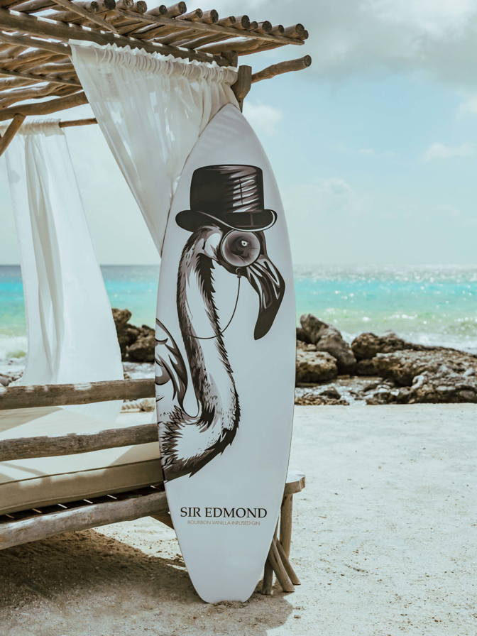 A Surfboard brandishing the SIr Edmond logo.