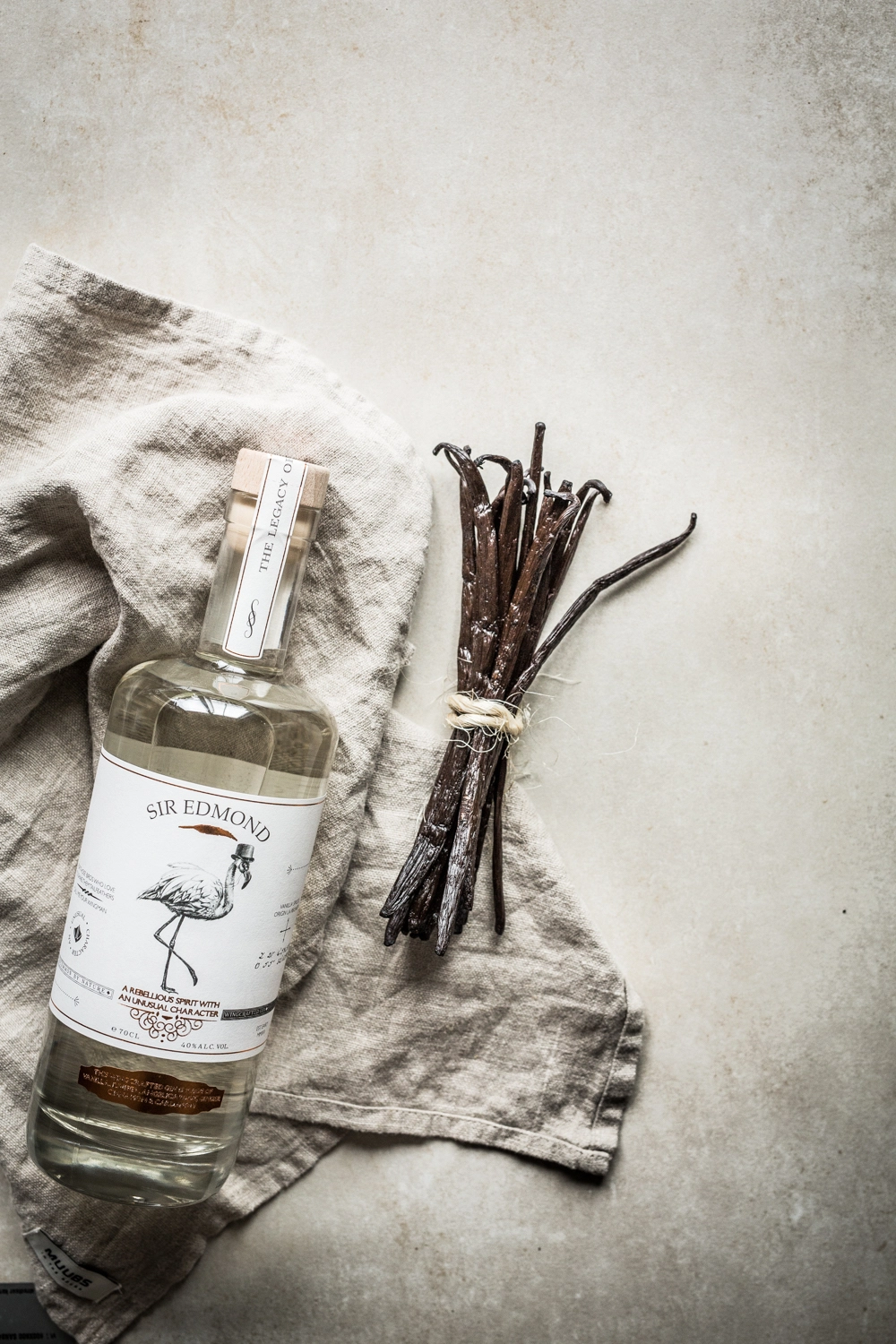 Branding image of Sir Edmond gin bottle and ingredients.